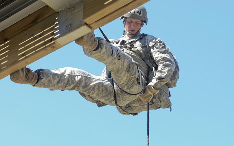 Sgt. Shaun Golike rappels from an obstacle at Camp Hovey on Thursday. More than 200 soldiers took part in the training, which preceded a 70- to 90- foot rappel from a helicopter on Friday. The soldiers are taking part in a 10-day Air Assault training course at camps Hovey and Casey in Dongducheon, South Korea.
