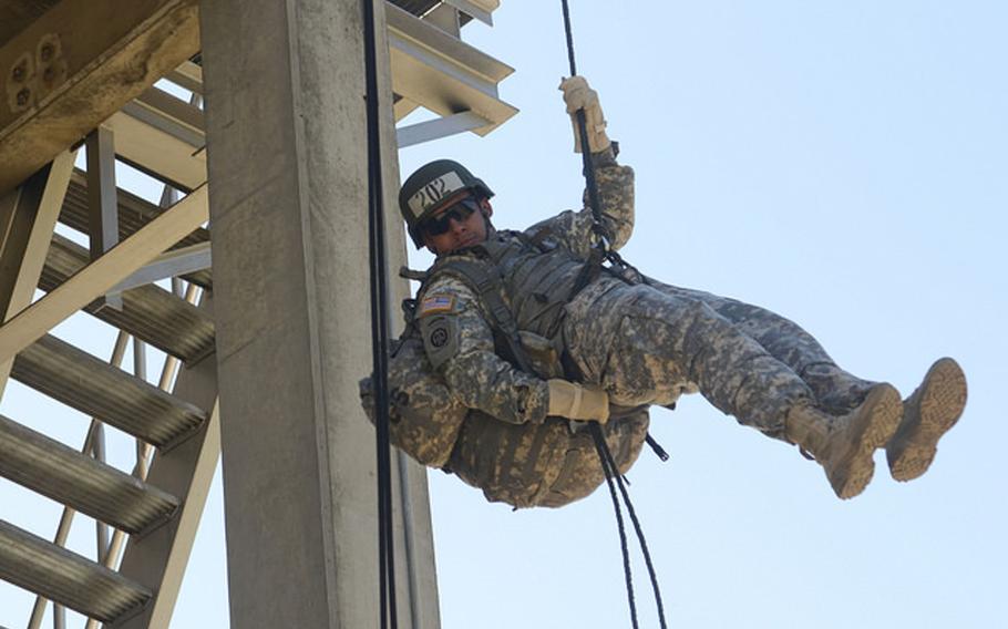 Sgt. Jose Carrillo rappels from an obstacle at Camp Hovey on Thursday. More than 200 soldiers took part in the training, which preceded a 70- to 90- foot rappel from a helicopter on Friday. The soldiers are taking part in a 10-day Air Assault training course at camps Hovey and Casey in Dongducheon, South Korea.