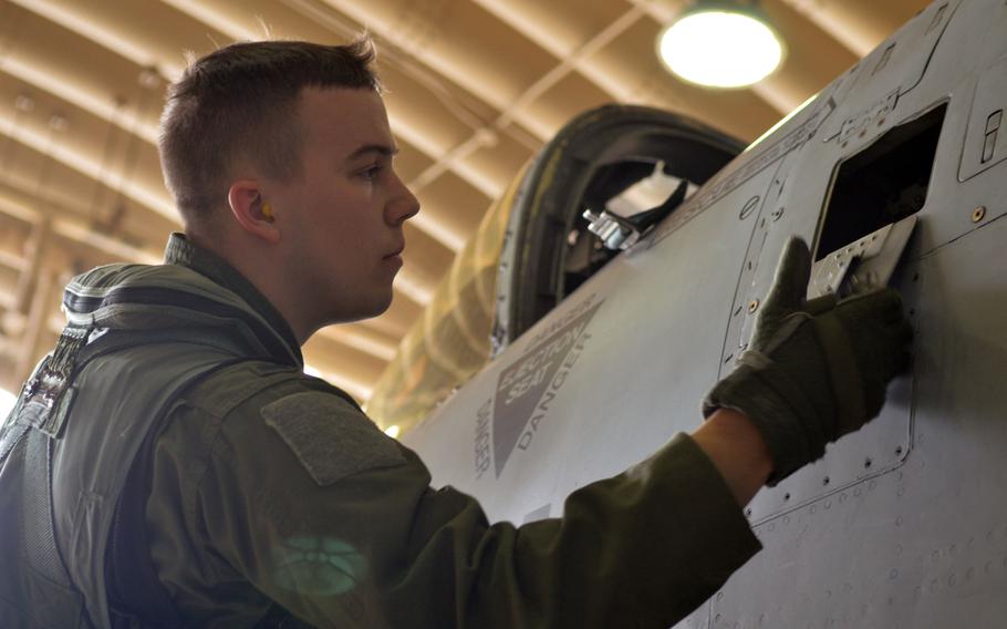 An Air Force pilot checks an outside panel of an A-10 Thunderbolt II  during the Beverly Bulldog 14-04 exercise at Osan Air Base, South Korea, on Sept. 18, 2014.