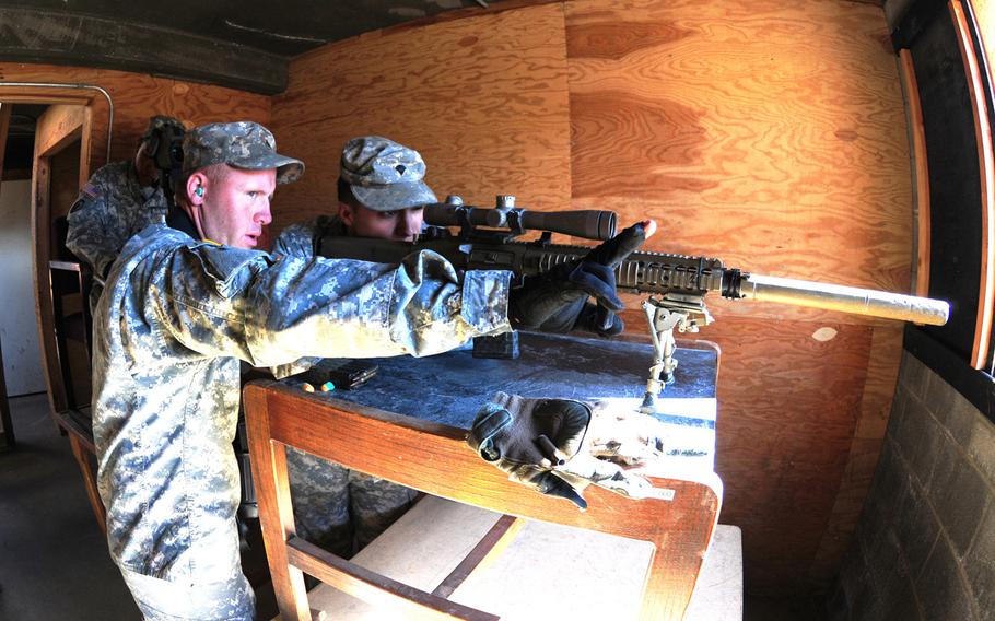 Sgt. Michael Garret, 4-23 Infantry Regiment, instructs Spc. Kevin Ryan before firing his weapon during a sniper exercise at Yakima Training Center, Wash., Sept. 10, 2014.