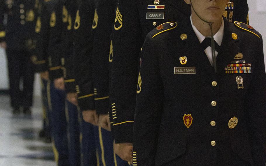 Competitors at the 2014 Army Drill Sergeant of the Year and Advanced Individual Training, Platoon Sergeant of the Year competitions prepare to take stage at the awards presentation.