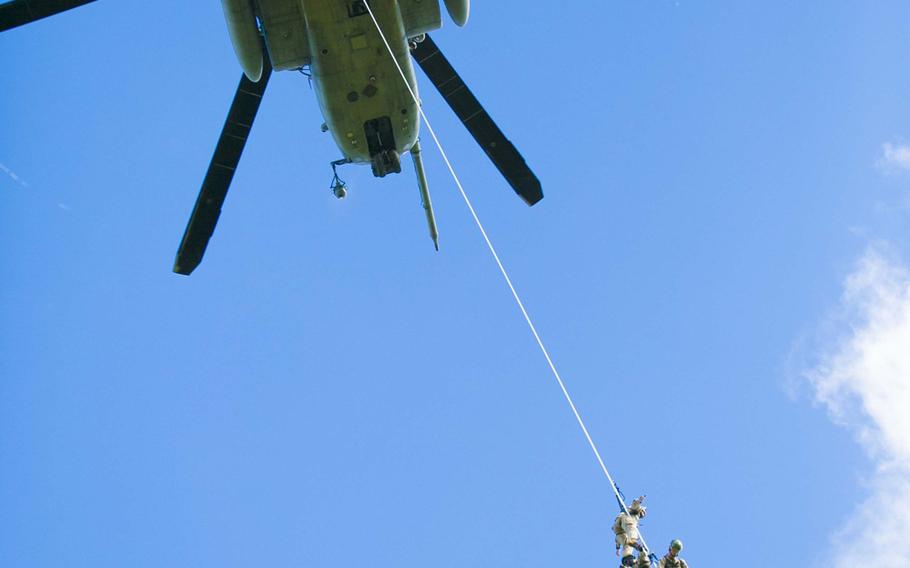 Marines perform Special Patrol Insertion/Extraction training on a CH-53E Super Stallion as part of the Helicopter Rope Suspension Techniques course Aug. 20, 2014, at the Central Training Area, Okinawa.
