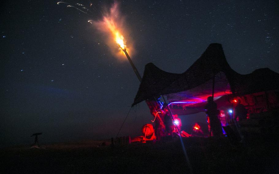 Marines fire an illumination round from an M777A2 lightweight 155 mm during live-fire artillery training Sept. 1, 2014, at the Yausubetsu Maneuver Area in Hokkaido, Japan, as part of Artillery Relocation Training Program 14-2.