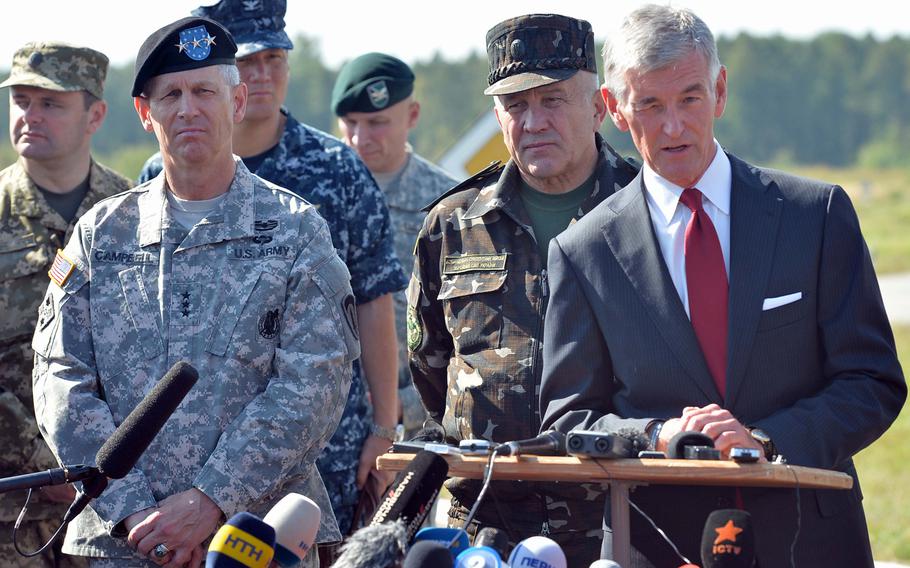 USAREUR commander Lt. Gen. Donald Campbell and Lt. Gen. Anatoliy Pushniakov, Ukrainian land forces commander, listen as Secretary of the Army John McHugh answers a journalist's question at Exercise Rapid Trident near Yavoriv, Ukraine, Friday, Sept. 19, 2014. About 1,300 troops from 15 countries are taking part in the exercise, which runs through Sept. 26.
