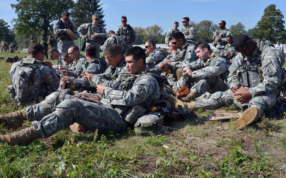 Soldiers of the 173rd Airborne Brigade have an MRE lunch after meeting Secretary of the Army John McHugh and USAREUR commander Lt. Gen. Donald Campbell  at Exercise Rapid Trident near Yavoriv, Ukraine, Friday, Sept. 19, 2014. It was media and VIP day at the exercise. About 1,300 troops from 15 countries are taking part in the exercise, which runs through Sept. 26.