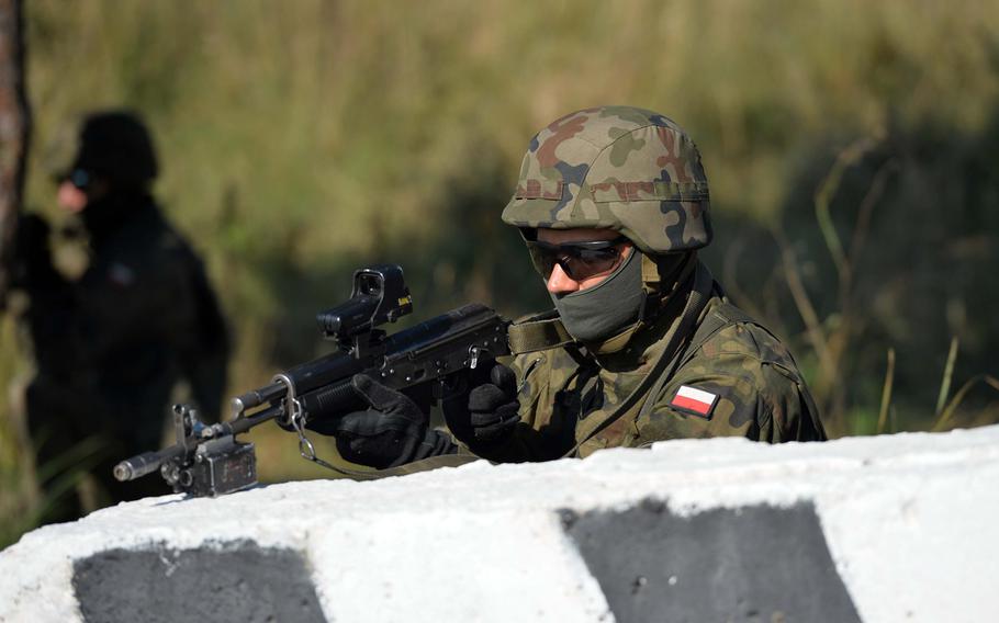 A Polish soldier guards the perimeter during a cordon-and-search exercise at Exercise Rapid Trident near Yavoriv, Ukraine, Friday, Sept. 19, 2014. Friday was media and VIP day at the exercise. Among the dignitaries watching the action were Secretary of the Army John McHugh, USAREUR commander Lt. Gen. Donald Campbell and Lt. Gen. Ben Hodges, commander NATO Allied Land Command.