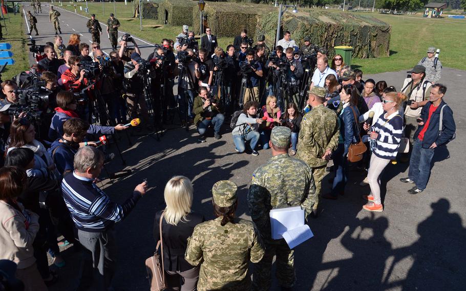 Journalists are briefed by soldiers at Exercise Rapid Trident near Yavoriv, Ukraine, Friday, Sept. 19, 2014. It was media and VIP day at the exercise and. Among the dignitaries watching the action were Secretary of the Army John McHugh, USAREUR commander Lt. Gen. Donald Campbell and Lt. Gen. Ben Hodges, commander NATO Allied Land Command. About 1,300 troops from 15 countries are taking part in the exercise, which runs through Sept. 26.