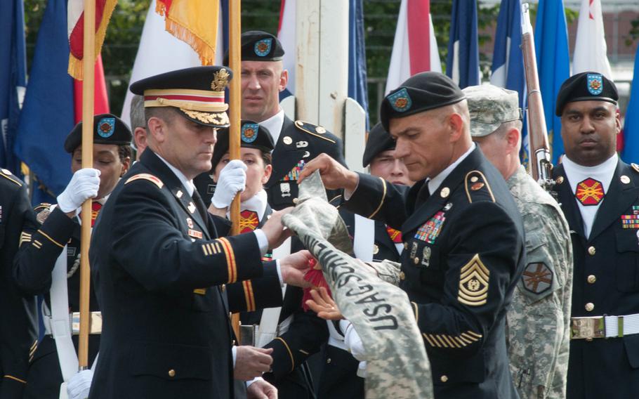 U.S. Army Garrison Ansbach commander Col. Christopher Benson and Command Sgt. Maj. Mark Kiefer case the Schweinfurt garrison colors at the base's closure ceremony, Sept. 19, 2014.