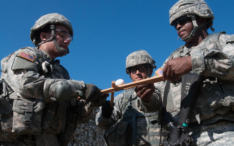 Members of the Europe Regional Medical Command team had to negotiate part of an obstacle course without breaking an egg and  using only three thin slats during the 2014 U.S. Army's "Best Warrior" competition in Grafenwohr, Germany, Sept. 17, 2014.