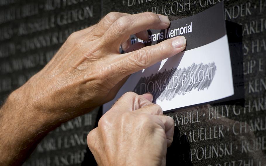 A Vietnam Veterans Memorial docent makes a rubbing for the family of Spc. 4 Donald P. Sloat who was posthumously awarded the Medal of Honor earlier this week, Washington, D.C., on Sept. 17, 2014.