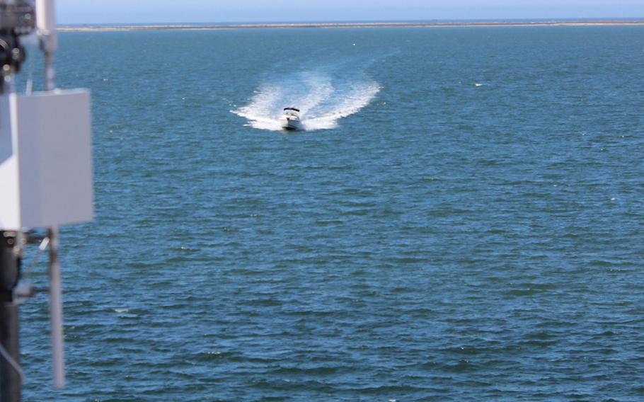 A small boat speeds toward the USS Rushmore, docked at Naval Base San Diego, as part of Citadel Protect, a training exercise simulating a terrorist attack, on Thursday, Sept. 25, 2014.