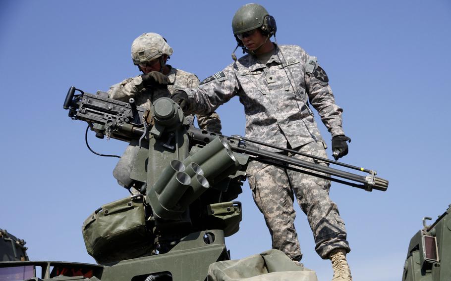 Soldiers with the 2nd Infantry Division?s ''Lancer'' Brigade prepare a 50-caliber machine gun atop a Stryker to fire blanks during training for a later live-fire practice assault during Garuda Shield in Indonesia.
