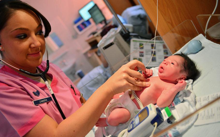 Staff Sgt. Tara Zamora, an 86th Medical Squadron medical technician, checks the temperature of an infant at  Landstuhl Regional Medical Center in Landstuhl, Germany, on June 18, 2014. LRMC is the largest American military hospital outside of the U.S.