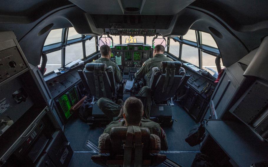 Capt. Ryan Heary, top left and Capt. Sean Jensen, top right, 37th Airlift Squadron pilots, prepare a C-130J Super Hercules before takeoff at Ramstein Air Base, Germany, on June 18, 2014.