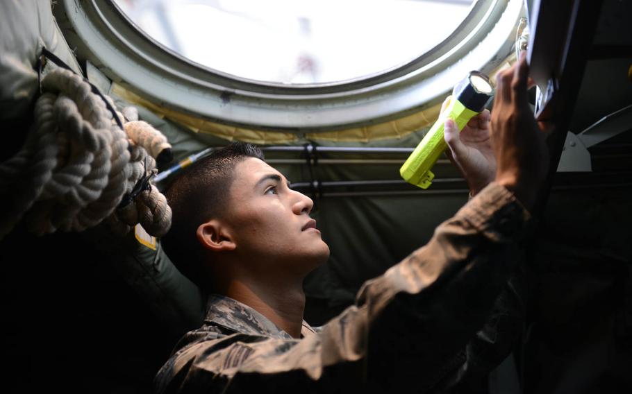 Senior Airman Michael Marquez, an 86th Maintenance Squadron crew chief, inspects a C-130J Super Hercules inside and out for any visible mechanical defects at Ramstein Air Base, Germany, on June 18, 2014.