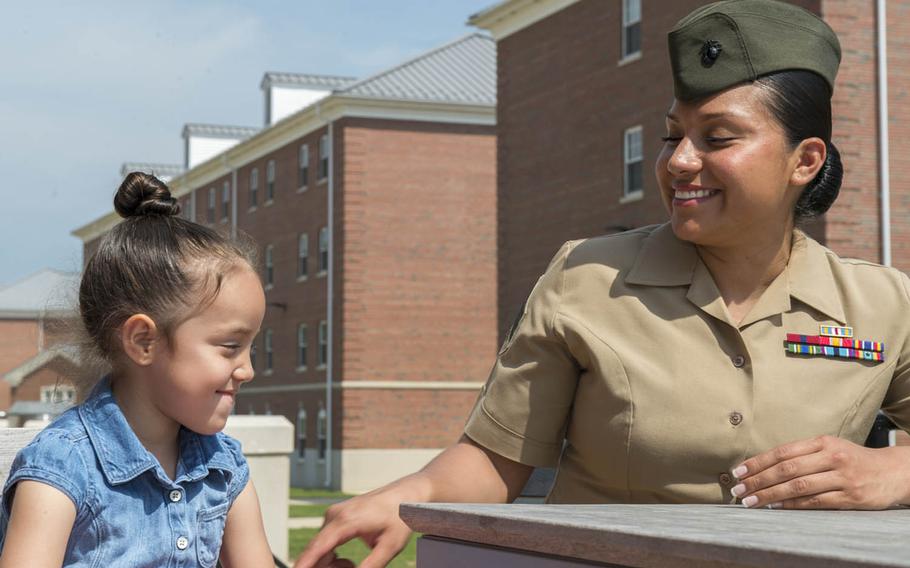 Marine Sgt. Jennifer Suarez laughs with her daughter during a visit to Marine Corps Base Quantico, Va., May 8, 2015. Suarez beat brain cancer to return to active duty.