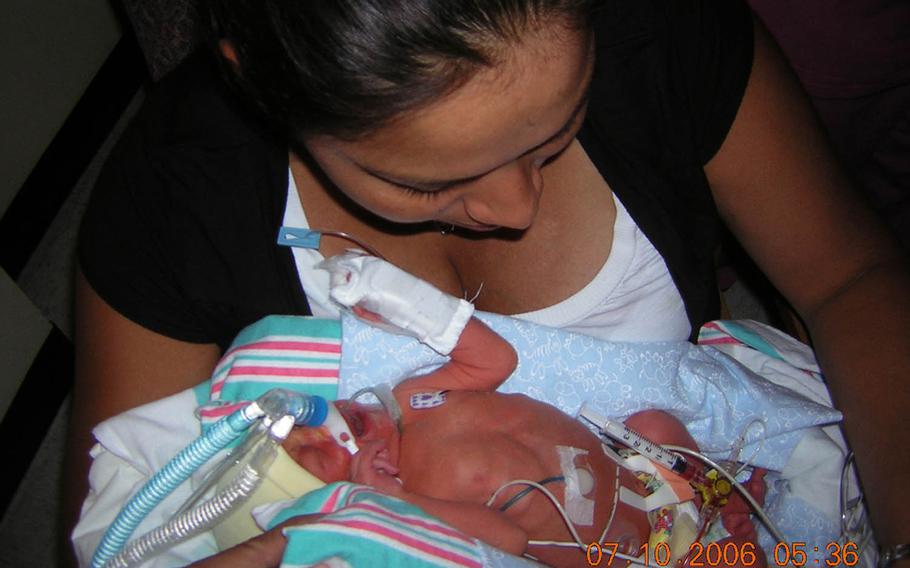 Marine Sgt. Jennifer Suarez holds her son, Anthony, on July 10, 2006, after he was born prematurely. Anthony's struggle with a failing heart and lungs mirrored her own battle against brain cancer, which was discovered shortly before his birth. The cancer has since gone into remission, and Suarez has returned to active duty in the Marine Corps. Anthony also recovered.