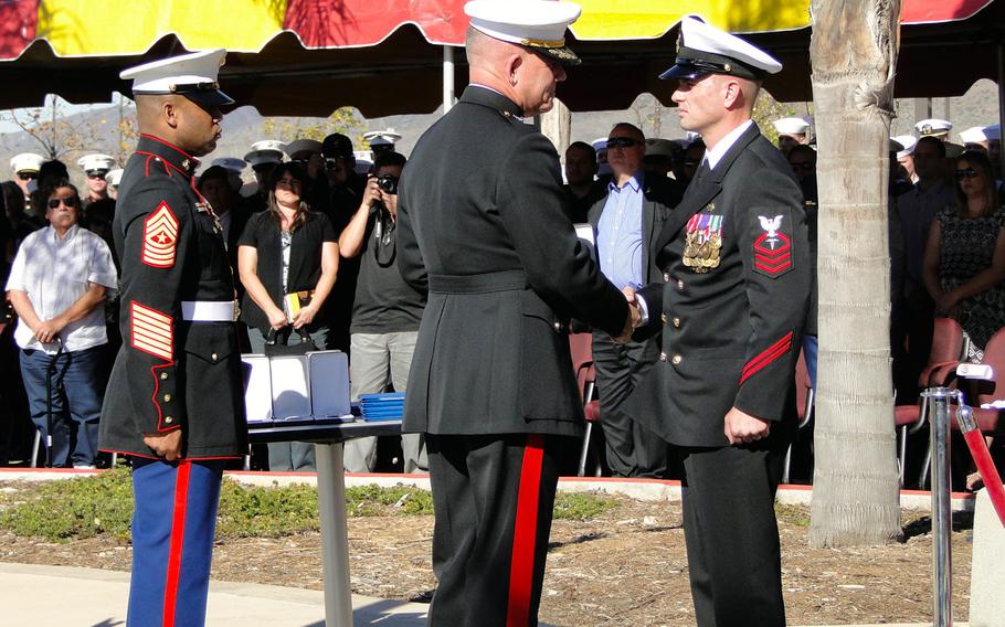 Maj. Gen. Joseph Osterman, commander of Marine Special Operations Command, presents a Navy Cross to Chief Petty Officer Justin Wilson on Nov. 25, 2014, at Camp Pendleton, Calif. Wilson is the first sailor in MARSOC history to receive the award.