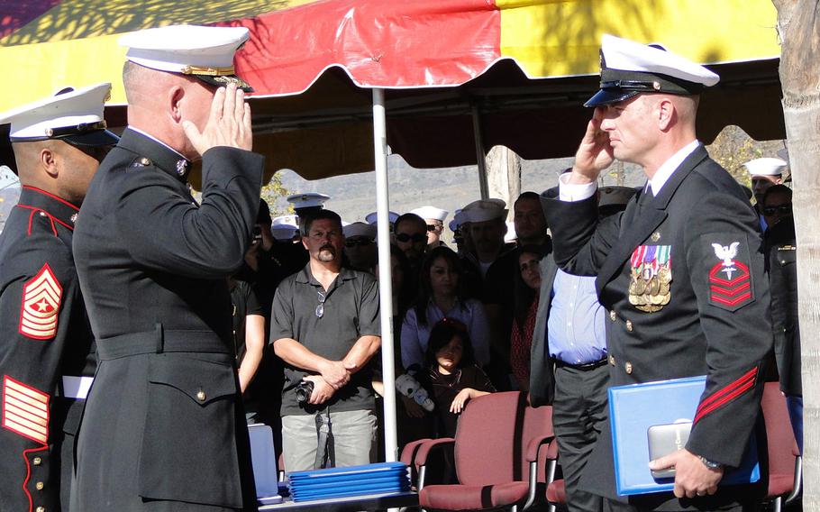 Maj. Gen. Joseph Osterman and Chief Petty Officer Justin Wilson salute after Wilson was awarded the Navy Cross on Nov. 25, 2014, at Camp Pendleton. Wilson earned the medal for his actions in Helmand province, Afghanistan, on Sept. 28, 2011.