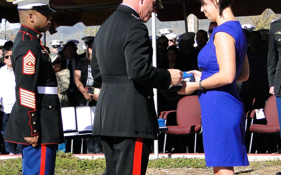 Maj. Gen. Jospeh Osterman, commander of Marine Special Operations Command, presents a Bronze Star with V to Tasha Sprovtsoff on behalf of her husband, Staff Sgt. Nicholas Sprovtsoff, on Nov. 25, 2014, at Camp Pendleton, Calif. Sprovtsoff was killed in an IED blast in Afghanistan in 2011.