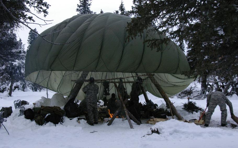 A parachute provides shelter for Army aviators during arctic survival training at the Northern Warfare Training Center in Alaska on Feb.10, 2015. 
