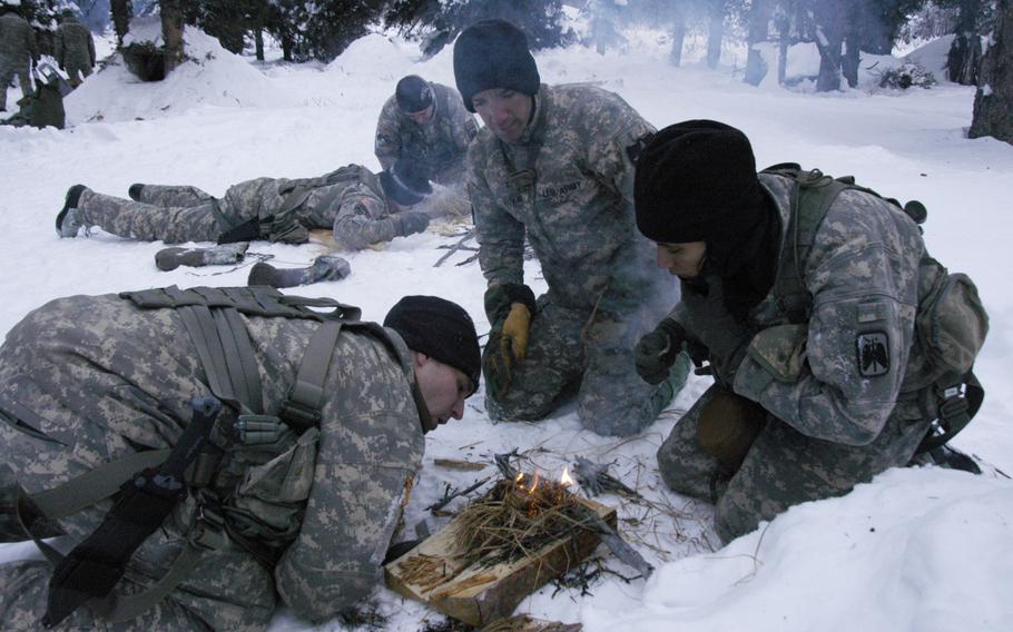 Army aviators make fires from dry grass during arctic survival training at the Northern Warfare Training Center in Alaska on Feb. 10, 2015. 