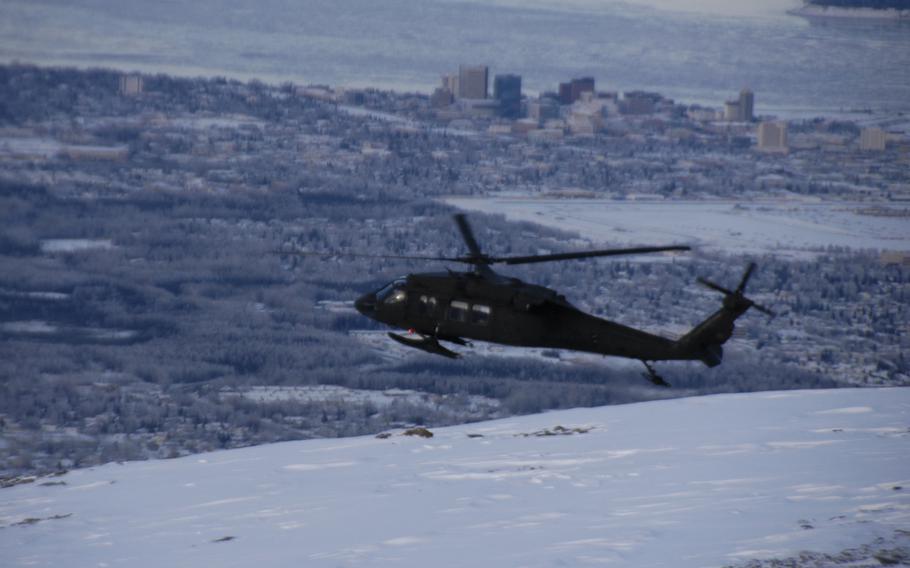 An Alaskan Army National Guard Black Hawk helicopter flies over Anchorage in February 2015.