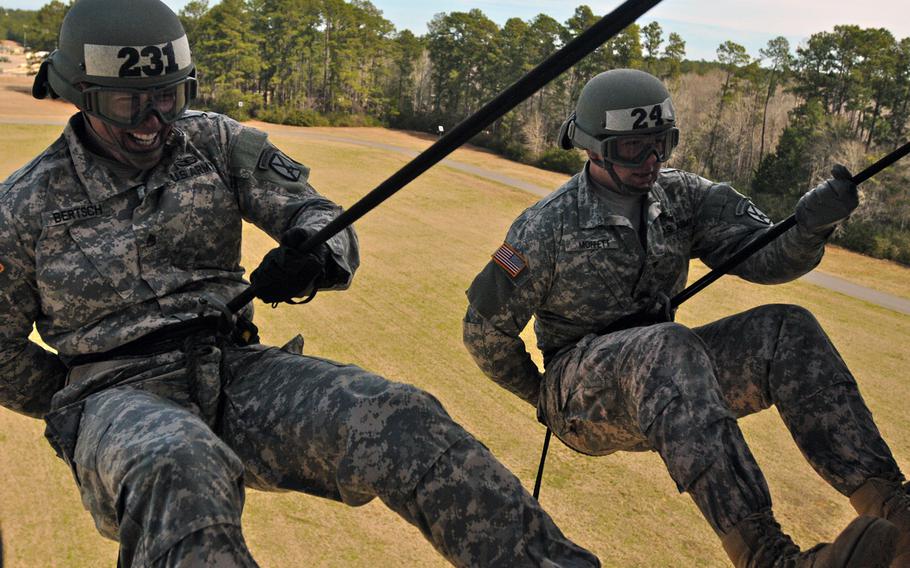 Candidates from across Fort Polk complete their final day of training during 10th Mountain Division?s Light Fighter School, Air Assault course, by rappelling from the bay of a UH-60 Black Hawk on Feb. 19, 2015 at Fort Polk?s Honor Fiel in Louisiana.