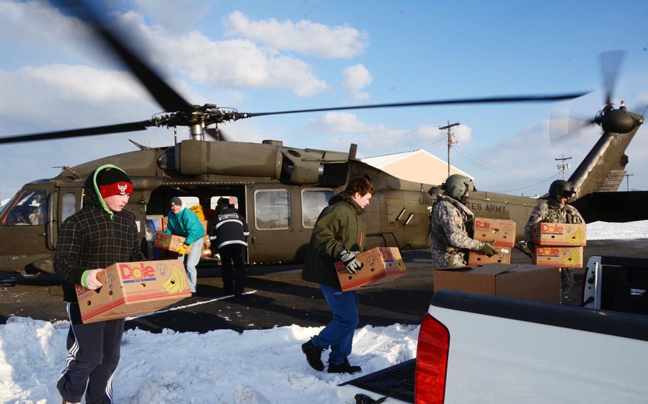 A Virginia Army National Guard aviation crew from the Sandston-based 2nd Battalion, 224th Aviation Regiment delivers food, mail and medicine on Feb. 19, 2015, to iced-in Tangier Island, Va.