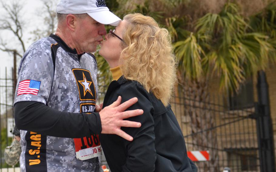 Lt. Gen. Perry L. Wiggins, U.S. Army North (Fifth Army) commanding general, Fort Sam Houston, shares a kiss with his wife, Annette, during the H-E-B Alamo Run Fest half marathon Feb. 22, 2015.