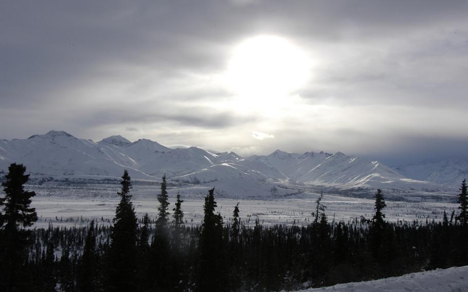The weak winter sun struggles to warm up a frozen landscape near Black Rapids Training Site, Alaska.