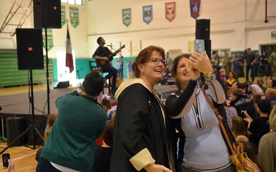 Audience members take selfies as former American Idol contestant Phillip Phillips performs at the USO Spring Troop visit in Naples, Italy, on Monday, March 3, 2015. Phillips is one of 10 celebrities joining Vice Chairman of the Joint Chiefs of Staff Adm. James "Sandy" Winnefeld on the tour, which was to visit overseas military bases over seven days.