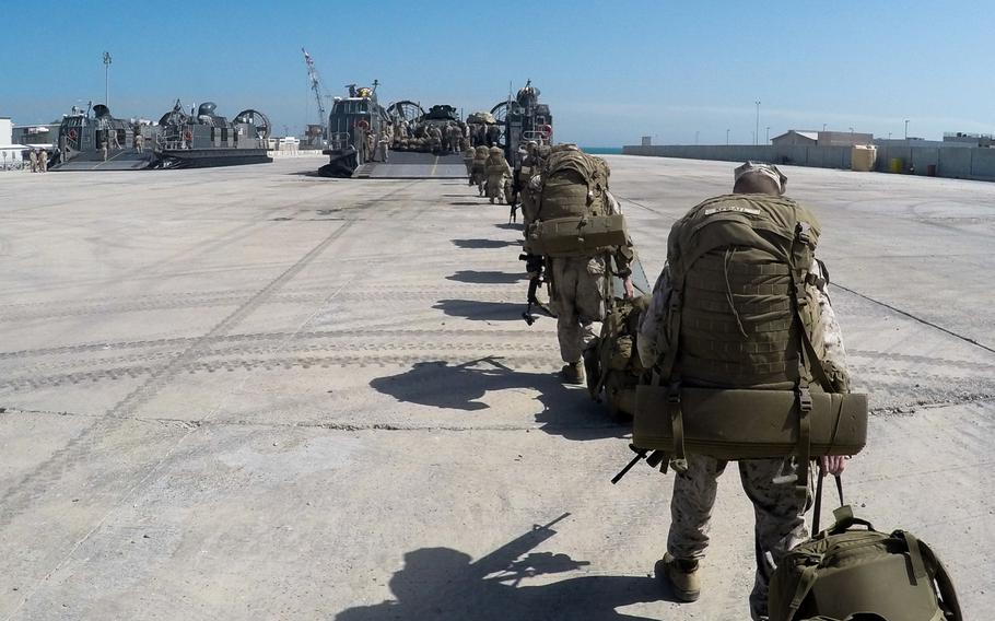 Marines with the 24th Marine Expeditionary Unit board a landing craft air-cushioned transport to return to the USS New York after spending a month training in Kuwait, Sunday, March 1, 2015. The ship and its embarked Marines are on an eight-month deployment to the U.S. 5th Fleet area of responsibility as part of the Iwo Jima amphibious ready group.