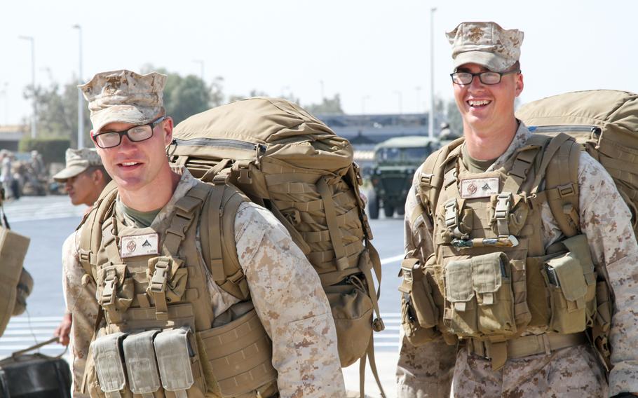 Two Marines from the 24th Marine Expeditionary Unit wait to board a landing craft air-cushioned transport to return to the USS New York, Sunday, March 1 2015. The ship and its embarked Marines are on an eight-month deployment to the U.S. 5th Fleet area of responsibility as part of the Iwo Jima amphibious ready group.