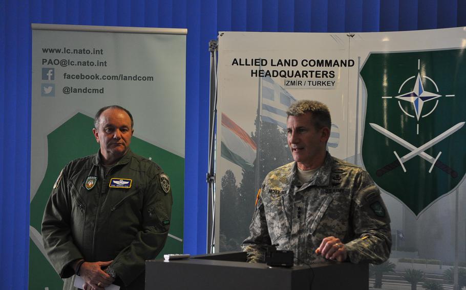 Gen. Philip Breedlove, NATO Supreme Allied Commander Europe, left, looks on while Lt. Gen. John W. Nicholson, Jr., NATO Allied Land Command commander, speaks Tuesday, March 10, 2015, at the NATO LANDCOM Corps Commanders' Conference at Ramstein Air Base, Germany. More than 140 participants from nearly all of the alliance's 28 member countries gathered to discuss the way ahead for NATO's ground forces amid a rapidly-changing security environment in Europe and elsewhere.