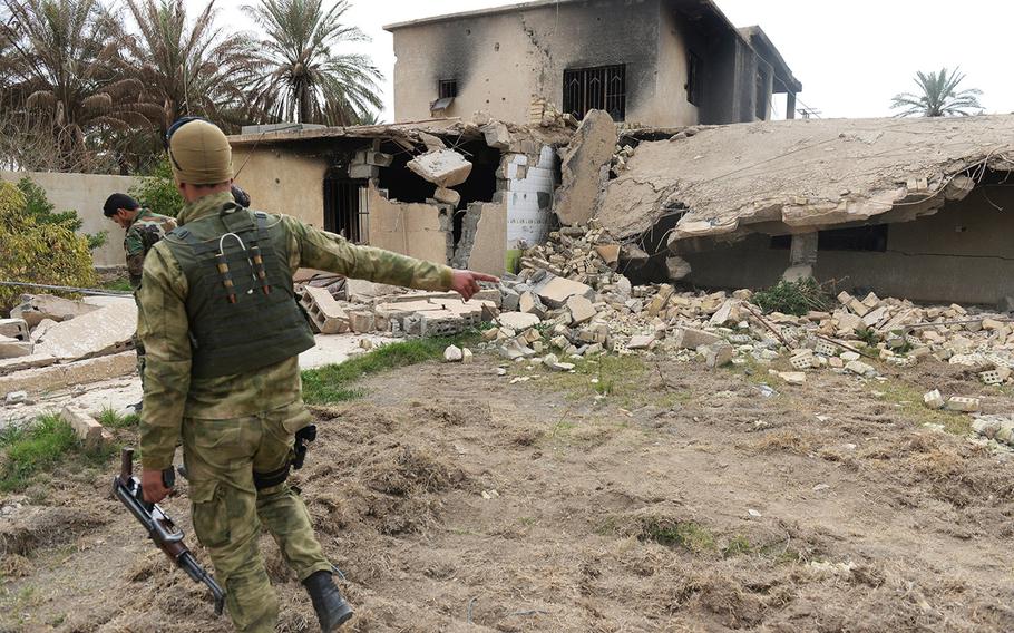 The purported former residence of an Islamic State commander lies in ruin in Jurf al-Nasr, Iraq, March 8, 2015. Government-backed militia patrolling the town say the building, like many others, was rigged to blow up before the militants were pushed out in October 2014.
