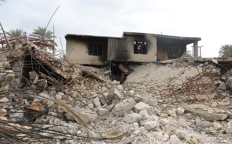 A building allegedly used by an Islamic State commander as a residence lies in ruin in Jurf al-Nasr, Iraq, March 8, 2015. This, like many other buildings in the town, was rigged to blow up before the militants were pushed out in October 2014.