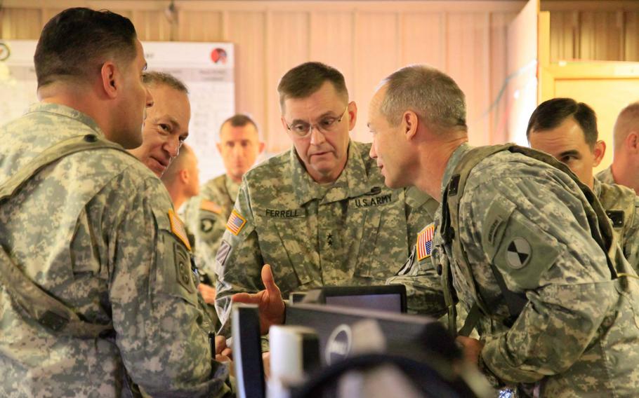 Lt. Gen. Stephen R. Lanza, I Corps commander, second from left, and Maj. Gen. Terry Ferrell, 7th Infantry Division commander, center, are  briefed by Task Force Bayonet leaders at the Joint Operations Center at Fort Polk. La., on Feb. 13, 2015, during a training exercise.  The task force, made up of about 50 soldiers from 7th Infantry Division and a dozen from 2nd Brigade Combat Team, will leave later this spring for a yearlong deployment to Kandahar Airfield, Afghanistan.