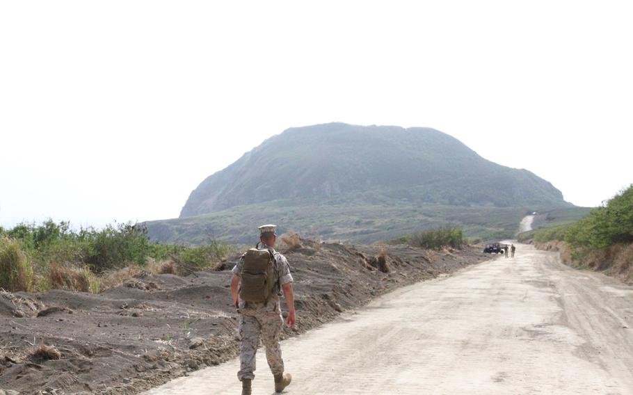 Master Gunnery Sgt. Kevin Gascon makes his way towards Iwo Jima's Mount Suribachi following the 70th anniversary ceremony. The mountain was the site of the iconic flag raising. Gascon would reach the summit a little over an hour later.

