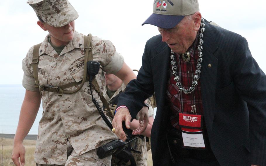 Marine Lance Cpl. Morgan Barnes helps steady Battle of Iwo Jima veteran and fellow Marine Carl DeHaven as he makes his way to the ceremony commemorating the 70th anniversary of the World War II battle.


