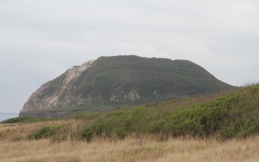 Mount Suribachi looms over the entire island of Iwo Jima, now called Iwo To by the Japanese who maintain the island as a military base. Seen here from a hill heading down to the beach. 

