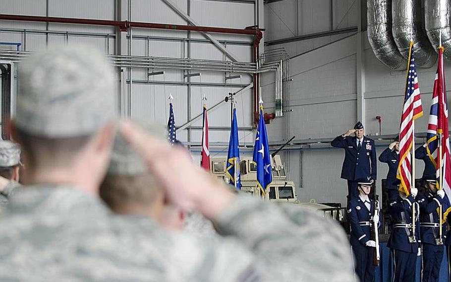 Lt. Gen. Bradley A. Heithold, commander of Air Force Special Operations, members of the audience salute during the opening of an activation ceremony at RAF Mildenhall, England, on Monday, March 23, 2015. The ceremony marked the deactivation of the 352nd Special Operations Group and its subsequent reactivation as a wing.

Adam L. Mathis/Stars and Stripes