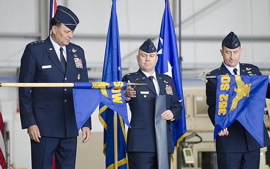 Lt. Gen. Bradley A. Heithold, commander of Air Force Special Operations, left, and Col. William G. Holt II, center, oversee the unfurlling of the 352nd Special Operations Wing flag, while Col. Nathan C. Green retires the 352nd Special Operations Group flag at RAF Mildenhall, England, on Monday, March 23, 2015. The 352nd has grown in the past few years from about 600 to about 1,200 airmen. 

Adam L. Mathis/Stars and Stripes