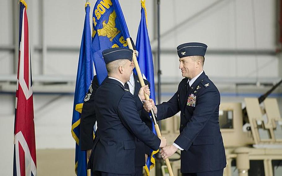 Col. William G. Holt II, commander of the 352nd Special Operations Wing, left, passes the flag for the 752nd Special Operations Group to Col. Nathan C. Green during an activation ceremony at RAF Mildenhall, England, on Monday, March 23, 2015. The ceremony marked the transformation of the 352nd Special Operations into a wing. 

Adam L. Mathis/Stars and Stripes