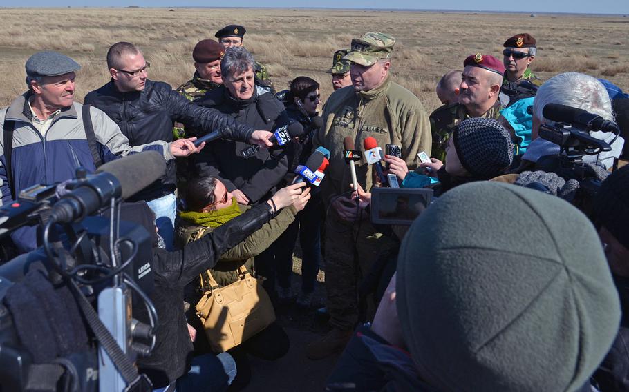 Lt. Gen. Ben Hodges, U.S. Army Europe commander, is interviewed by the Romanian media at the Smarden Training Area in Romania, on Tuesday, March 24, 2015, after watching the 173rd Airborne Brigade parachute into the training area.