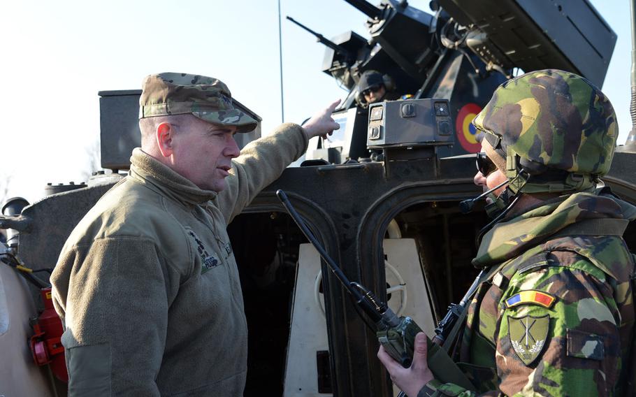 Lt. Gen. Ben Hodges, left, talks to a Romanian soldier about his armored vehicle at the Smarden Training Area in Romania, in March 2015. The U.S. is considering a plan to expand its military training of Ukrainian forces to include army soldiers, the commander of the U.S. Army in Europe said Monday, July 13, 2015.