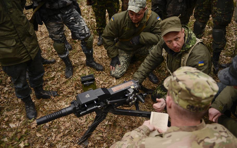 Ukrainian soldiers go over basic weapons procedures with a soldier from the 173rd Airborne Brigade on April 21, 2015, the first day of training in Yavoriv, Ukraine.