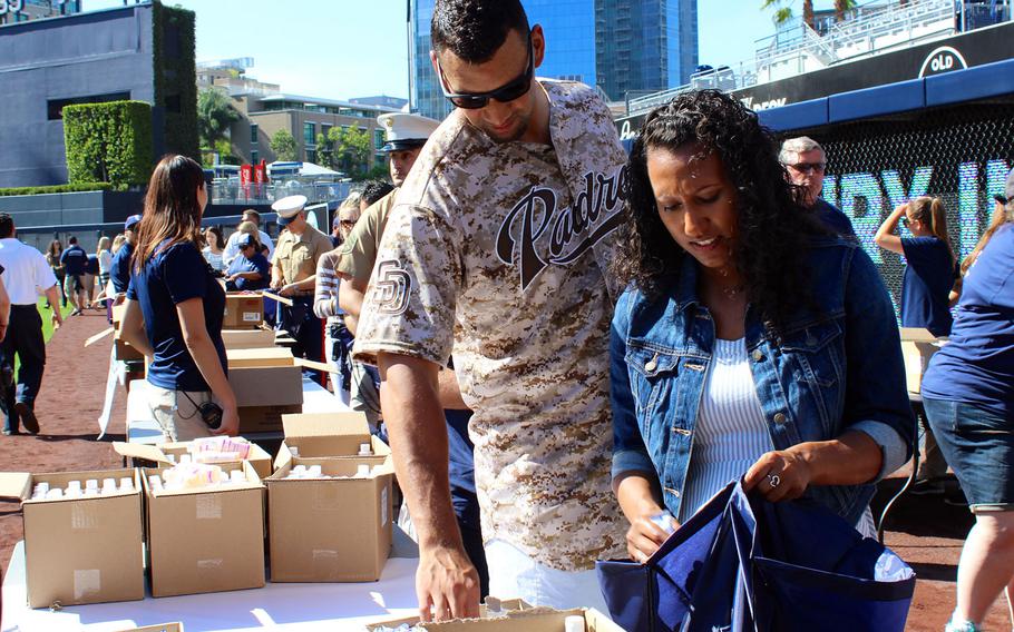 San Diego Padres pitcher Tyson Ross and his girlfriend, Ashley Hoffman, assemble care packages for deployed troops, Wednesday at Petco Park. Mercury Insurance worked with the Padres to put together and send 1,000 packages to Marines and sailors with I Marine Expeditionary Force.