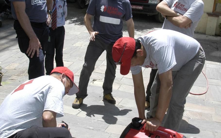 Team Rubicon members prepare gear for an aid mission departing Kathmandu, Nepal, on Sunday, May 3, 2015.