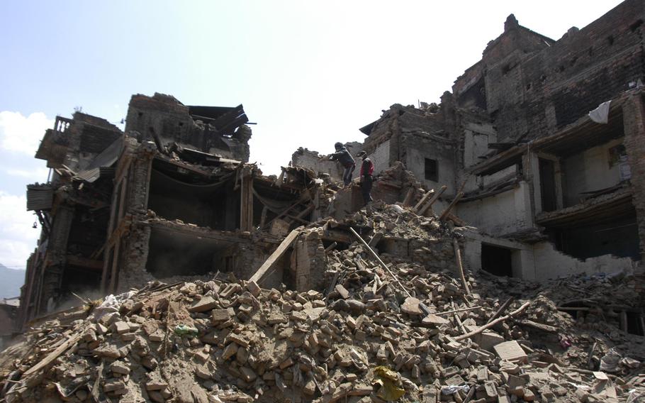 Earthquake survivors move rubble in Bhaktapur, Nepal, Tuesday, May 5, 2015.